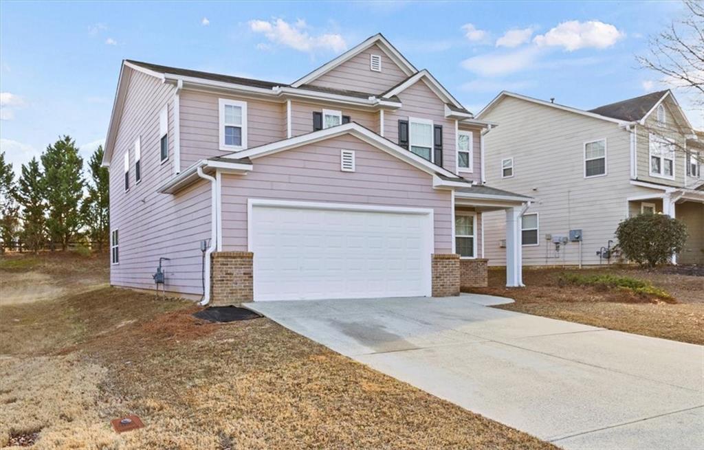 125 Parkmont Court Dallas, GA 30132 - Photo 2 of 36 a front view of a house with a yard and garage
