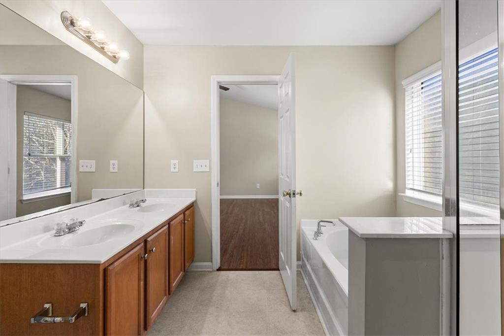 125 Parkmont Court Dallas, GA 30132 - Photo 26 of 36 a spacious bathroom with a bathtub sink and mirror