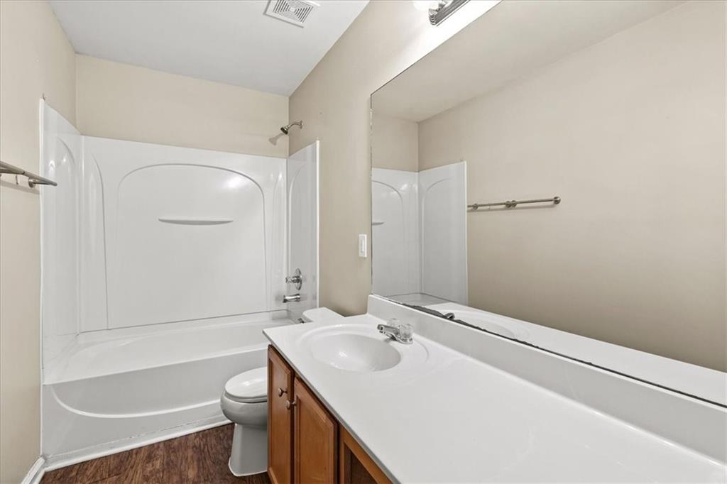 125 Parkmont Court Dallas, GA 30132 - Photo 32 of 36 a bathroom with a sink toilet vanity and shower