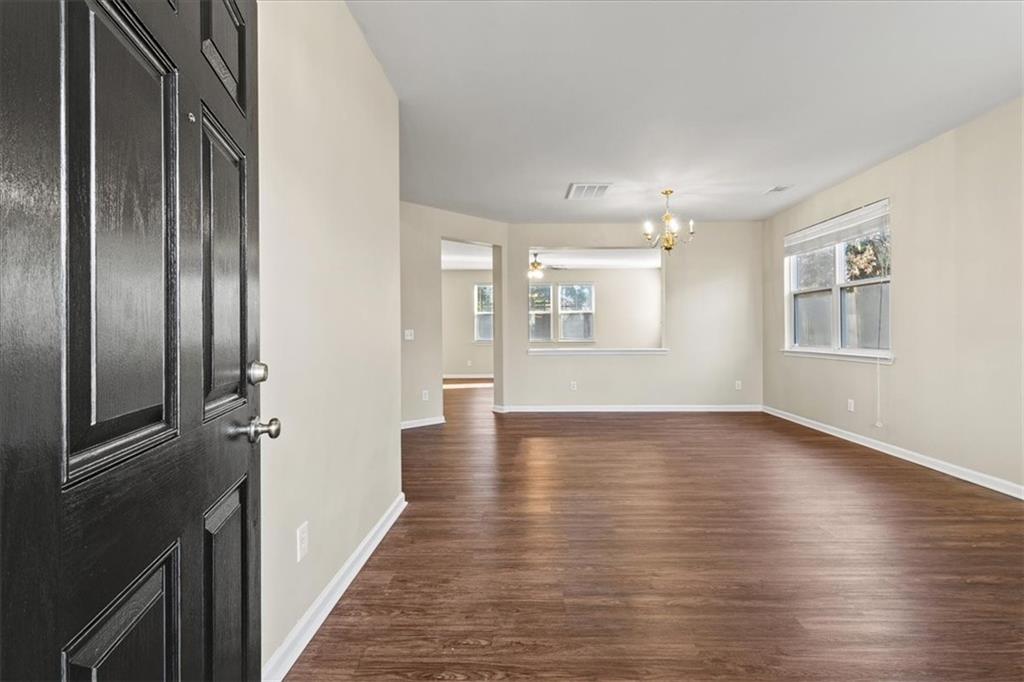 125 Parkmont Court Dallas, GA 30132 - Photo 6 of 36 an empty room with wooden floor and windows