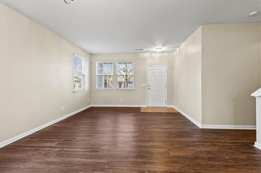 125 Parkmont Court Dallas, GA 30132 - Photo 7 of 36 a view of an empty room with wooden floor and a window