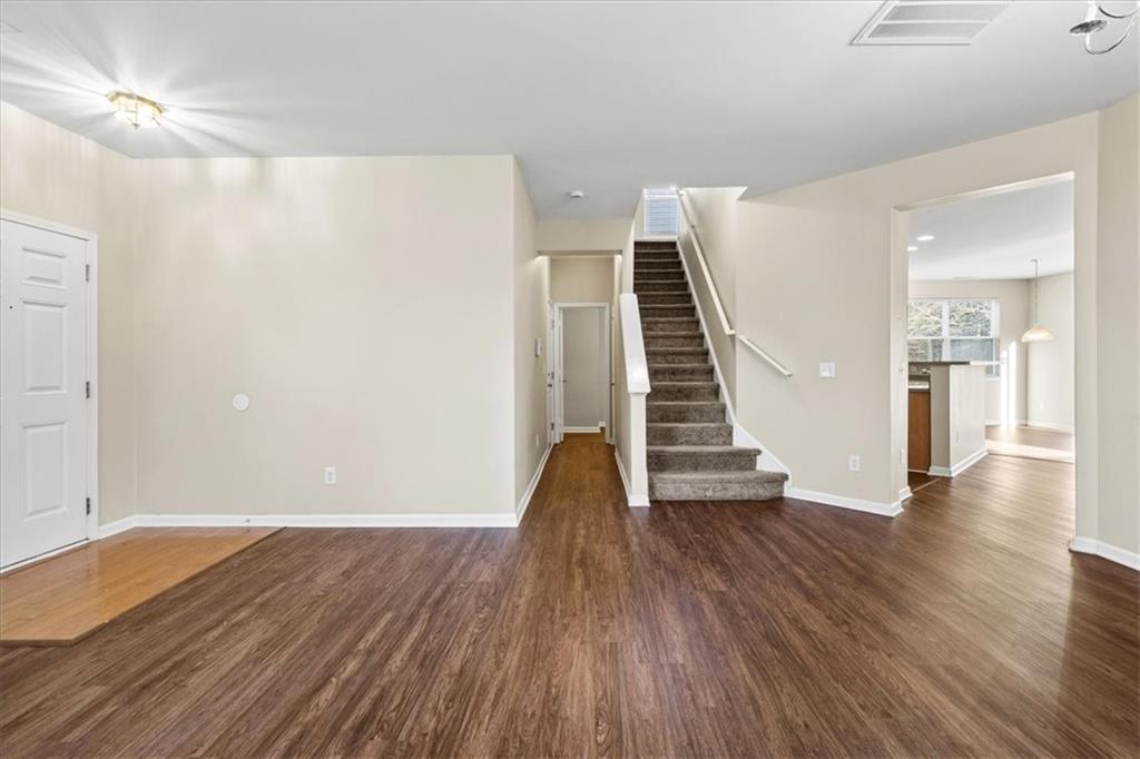 125 Parkmont Court Dallas, GA 30132 - Photo 9 of 36 a view of a room with wooden floor and stairs