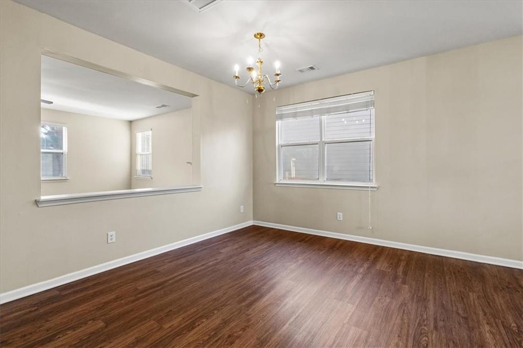 125 Parkmont Court Dallas, GA 30132 - Photo 10 of 36 a view of an empty room with window and wooden floor