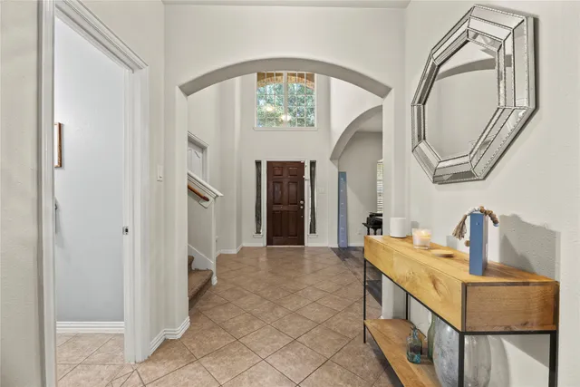 a spacious bathroom with a mirror and a sink