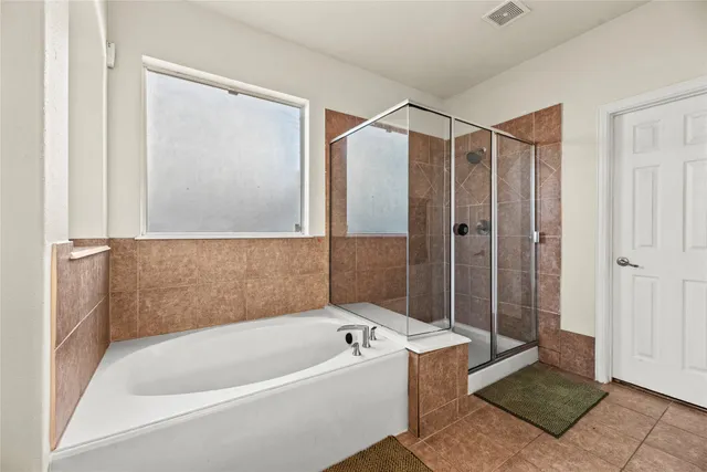 a bathroom with a bathtub and a shower
