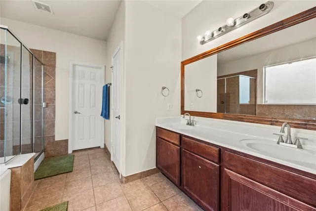 a spacious bathroom with a sink and a mirror