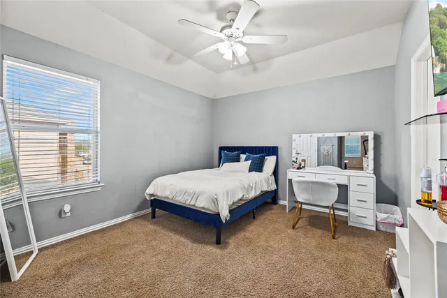 a spacious bedroom with a bed and a table in it