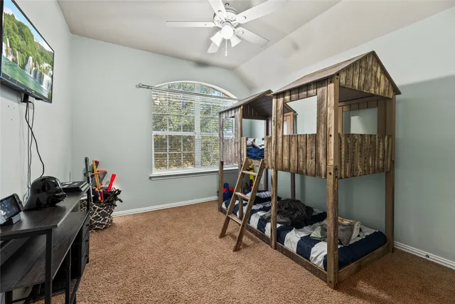 a living room with furniture gym equipment and a chandelier