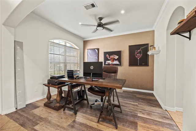 a view of a workspace with furniture and a window