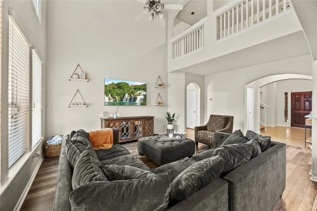 a living room with furniture a fireplace and a chandelier
