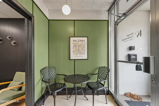 a view of a hallway with furniture and front door