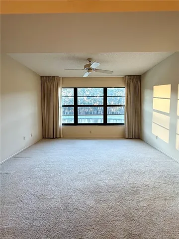 an empty room with a window and a fireplace