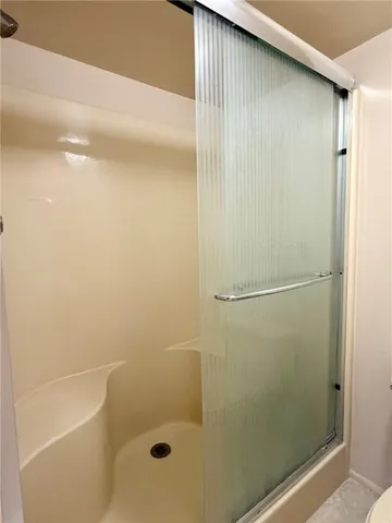 a bathroom with a glass shower door