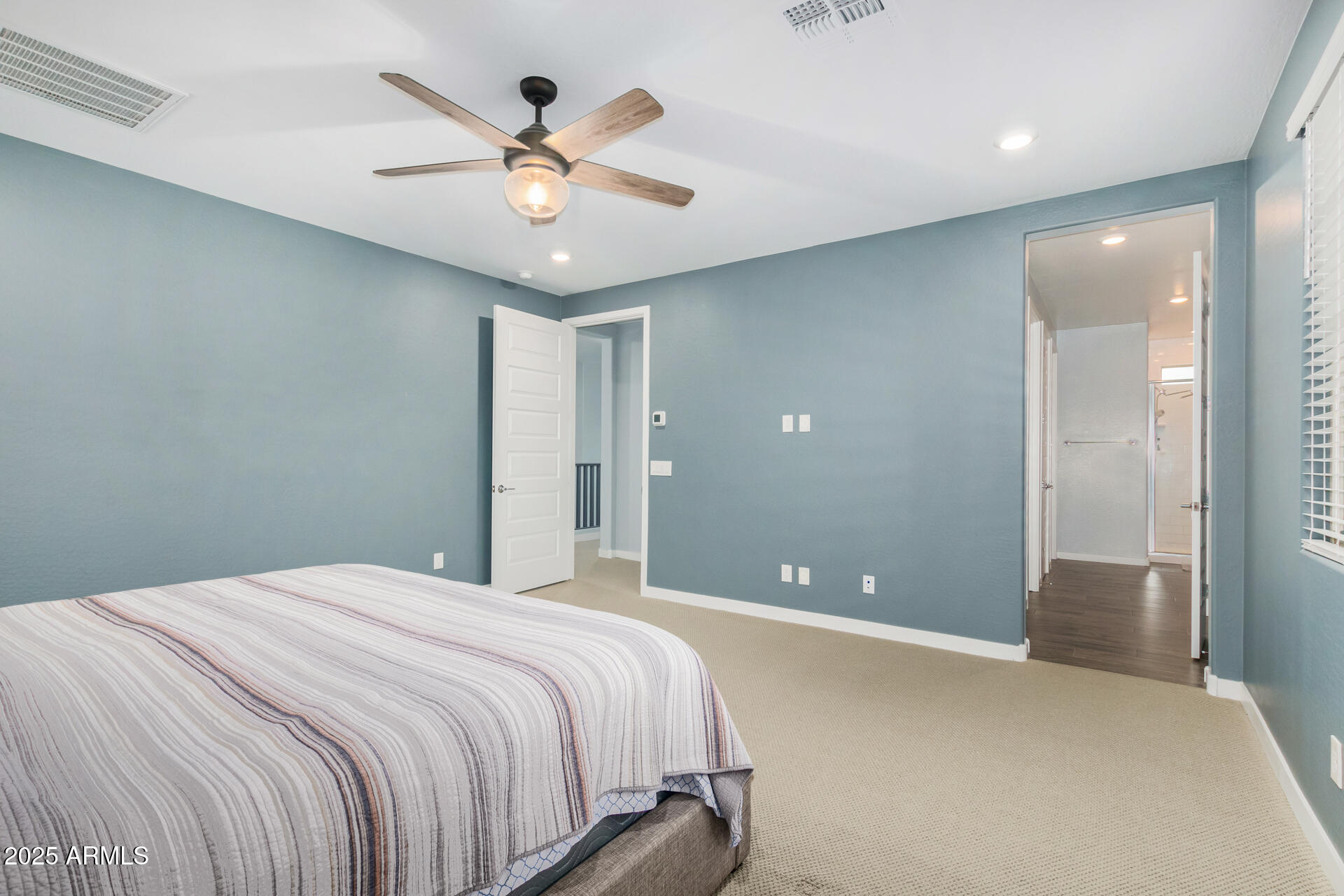 1171 East Armstrong Way Chandler, AZ 85286 - Photo 13 of 30 a bedroom with a large bed chandelier and a ceiling fan