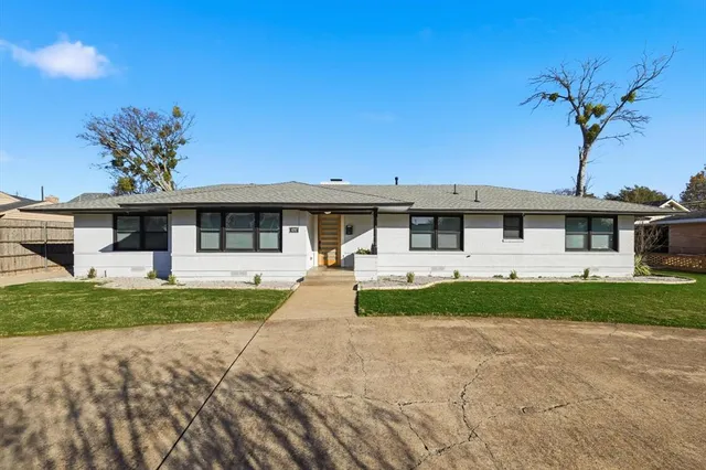 front view of a house next to a yard