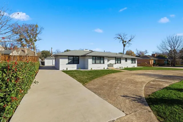 a front view of a house with a garden