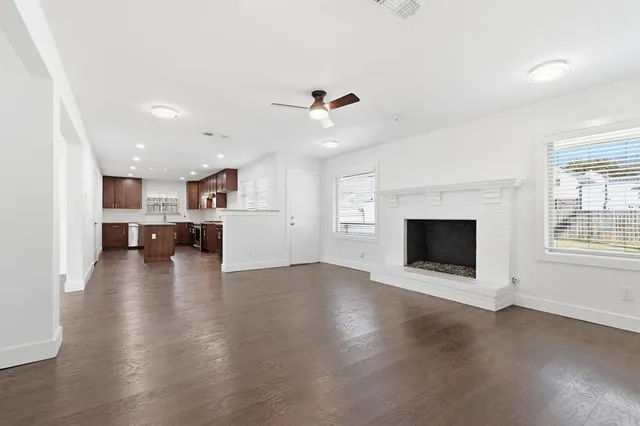 an empty room with fireplace fireplace and windows