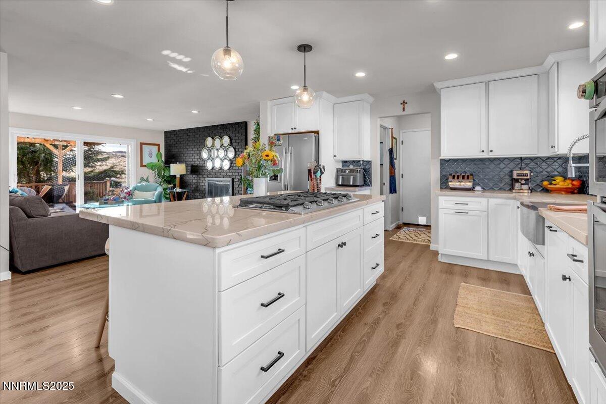 3880 Piccadilly Drive Reno, NV 89509 - Photo 12 of 58 a large kitchen with kitchen island a large counter space a sink appliances and cabinets