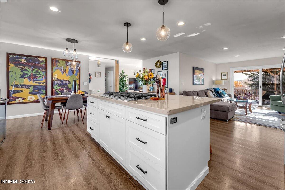 3880 Piccadilly Drive Reno, NV 89509 - Photo 13 of 58 a large white kitchen with lots of counter space dining table and chairs