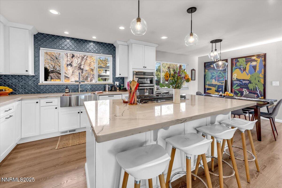 3880 Piccadilly Drive Reno, NV 89509 - Photo 14 of 58 a kitchen with stainless steel appliances granite countertop a kitchen island a stove and a sink