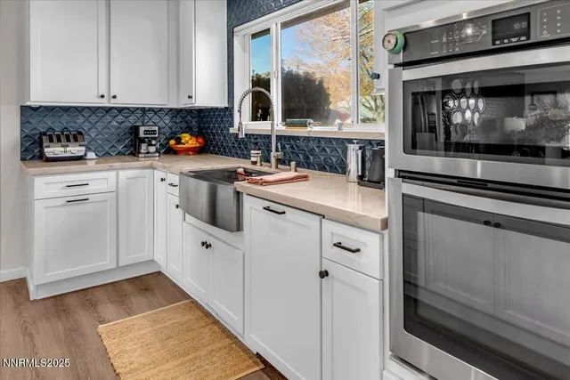 a kitchen with white cabinets and white appliances