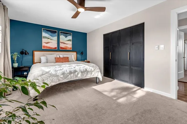 a bedroom with a bed table and window