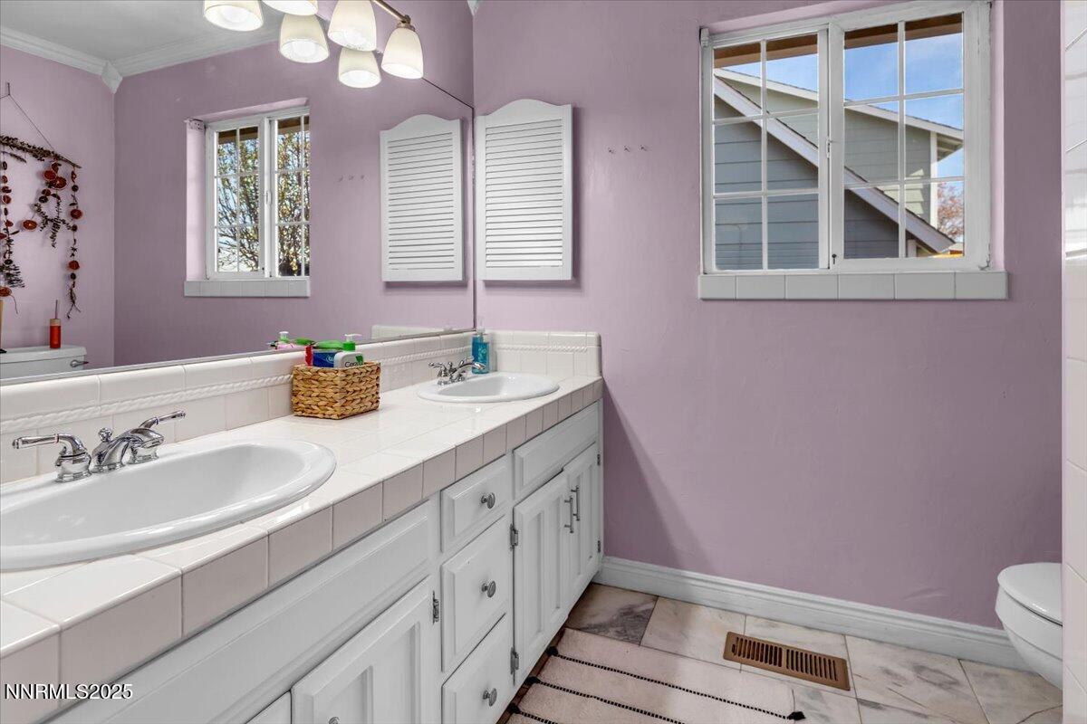 3880 Piccadilly Drive Reno, NV 89509 - Photo 33 of 58 a bathroom with a granite countertop sink mirror vanity and toilet