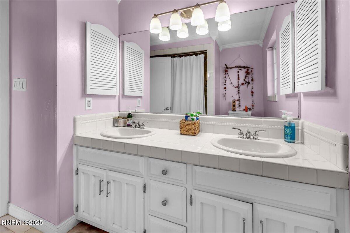 3880 Piccadilly Drive Reno, NV 89509 - Photo 34 of 58 a bathroom with a sink double vanity and a mirror