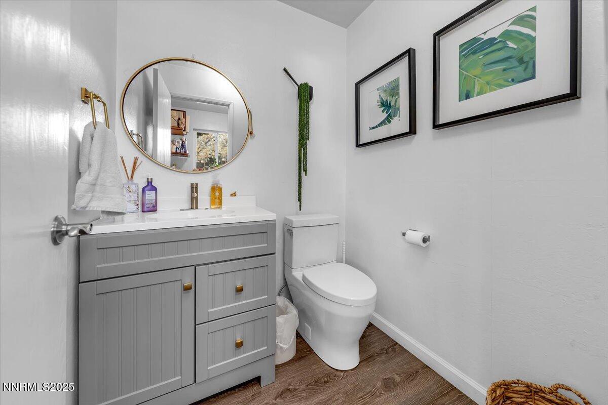3880 Piccadilly Drive Reno, NV 89509 - Photo 37 of 58 a bathroom with a toilet a sink and a mirror
