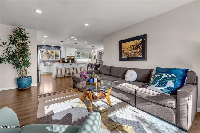 a living room with furniture and kitchen view