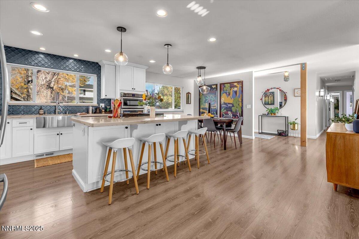 3880 Piccadilly Drive Reno, NV 89509 - Photo 9 of 58 a dining room with stainless steel appliances granite countertop furniture wooden floor and a kitchen view