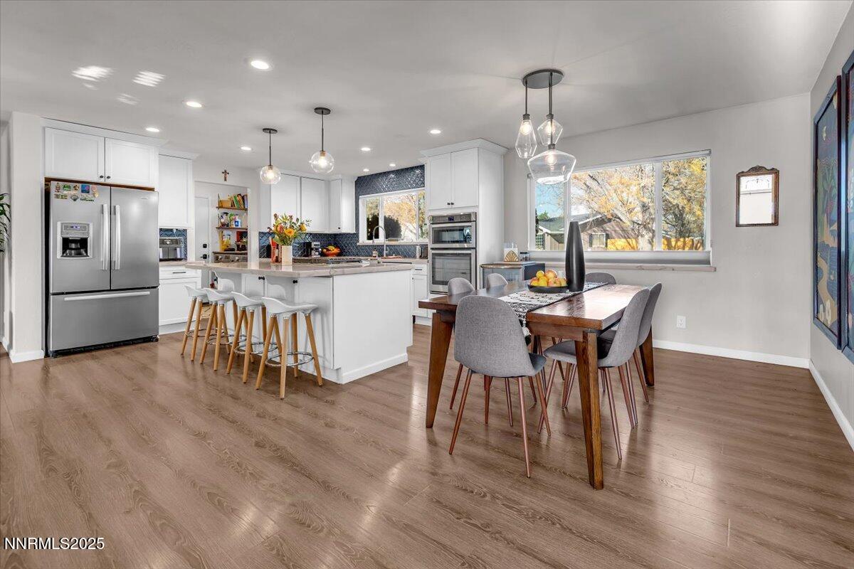 3880 Piccadilly Drive Reno, NV 89509 - Photo 10 of 58 a view of a dining room with furniture a kitchen and chandelier
