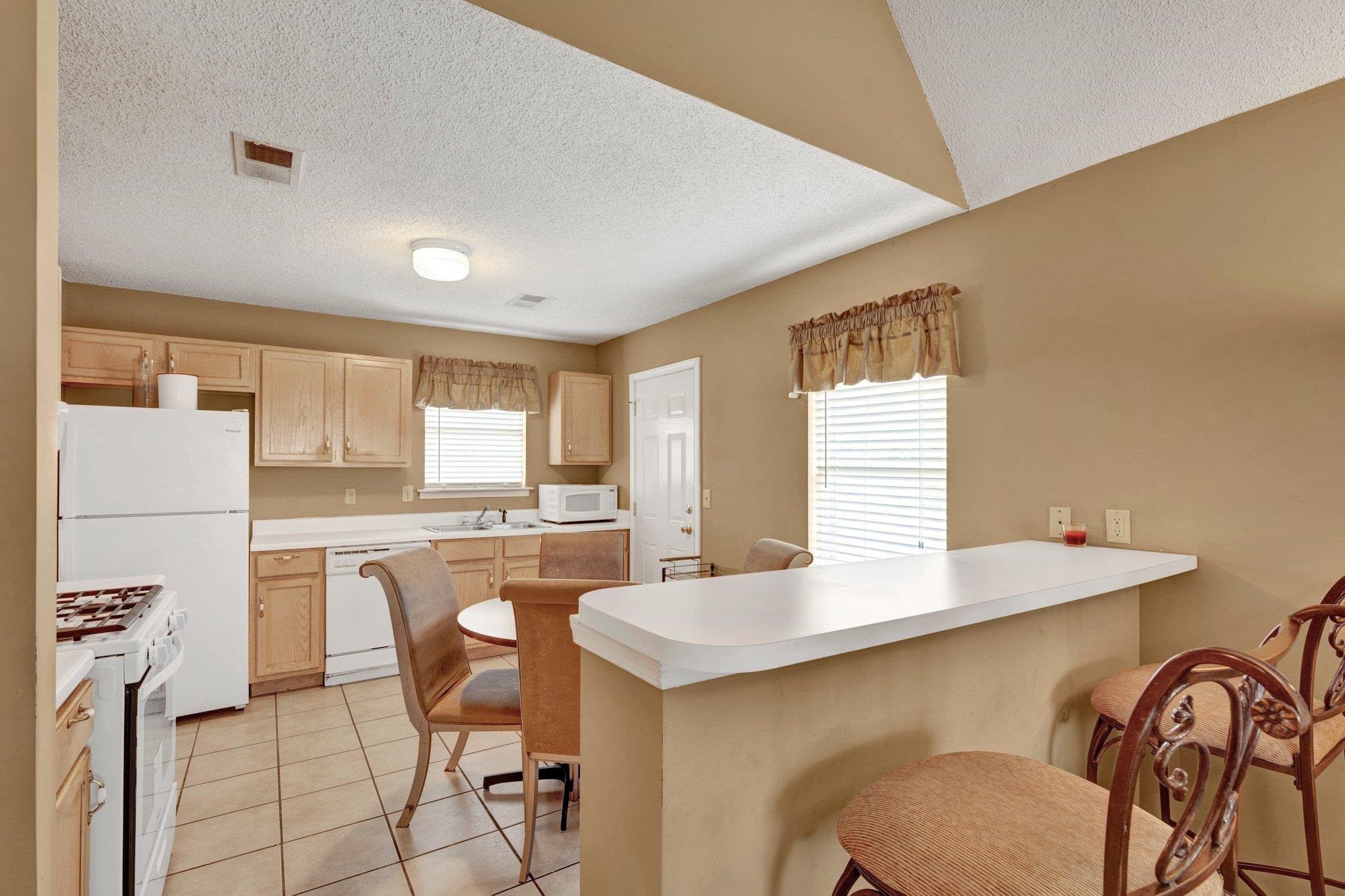 385 Boston Street Memphis, TN 38111 - Photo 5 of 11 a kitchen with a table chairs stove and refrigerator