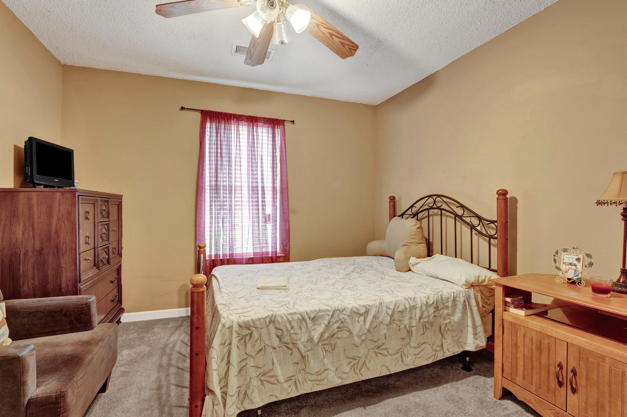 385 Boston Street Memphis, TN 38111 - Photo 9 of 11 a bedroom with a bed and wooden floor