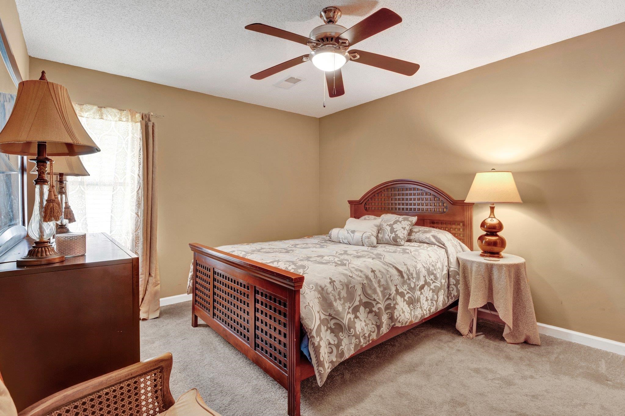 385 Boston Street Memphis, TN 38111 - Photo 10 of 11 a bedroom with a bed and a chandelier