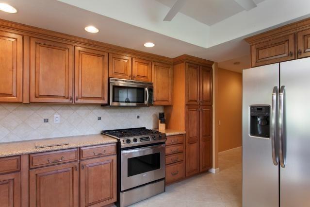 72300 Rodeo Way Rancho Mirage, CA 92270 - Photo 11 of 34 a kitchen with stainless steel appliances granite countertop a refrigerator stove and sink