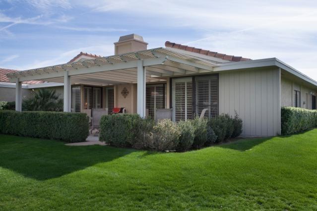 72300 Rodeo Way Rancho Mirage, CA 92270 - Photo 23 of 34 a view of a house with brick walls and a yard with plants