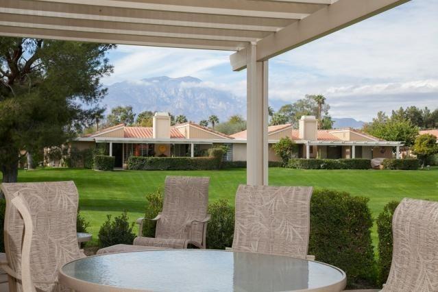 72300 Rodeo Way Rancho Mirage, CA 92270 - Photo 27 of 34 a view of a house with a big yard potted plants and a fountain