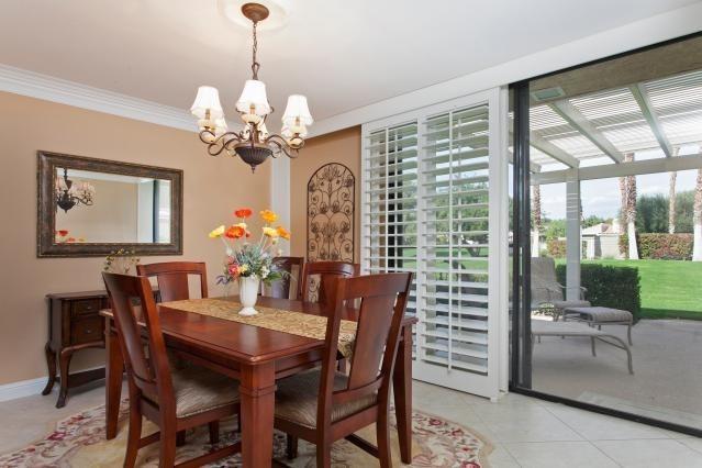 72300 Rodeo Way Rancho Mirage, CA 92270 - Photo 9 of 34 a dining room with furniture a large window and a chandelier