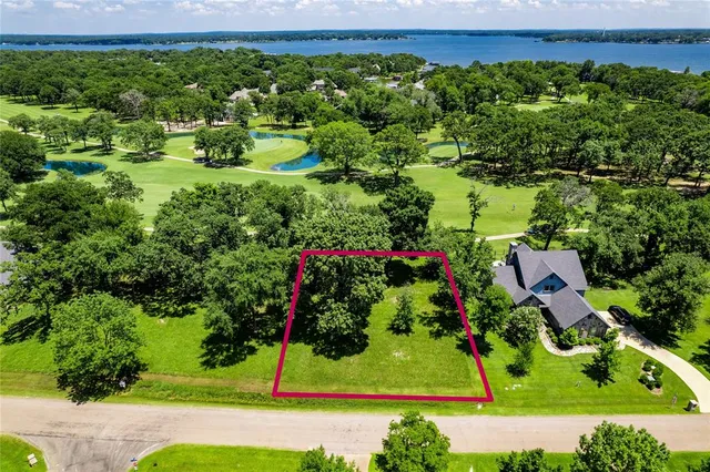 an aerial view of a house with a yard and garden