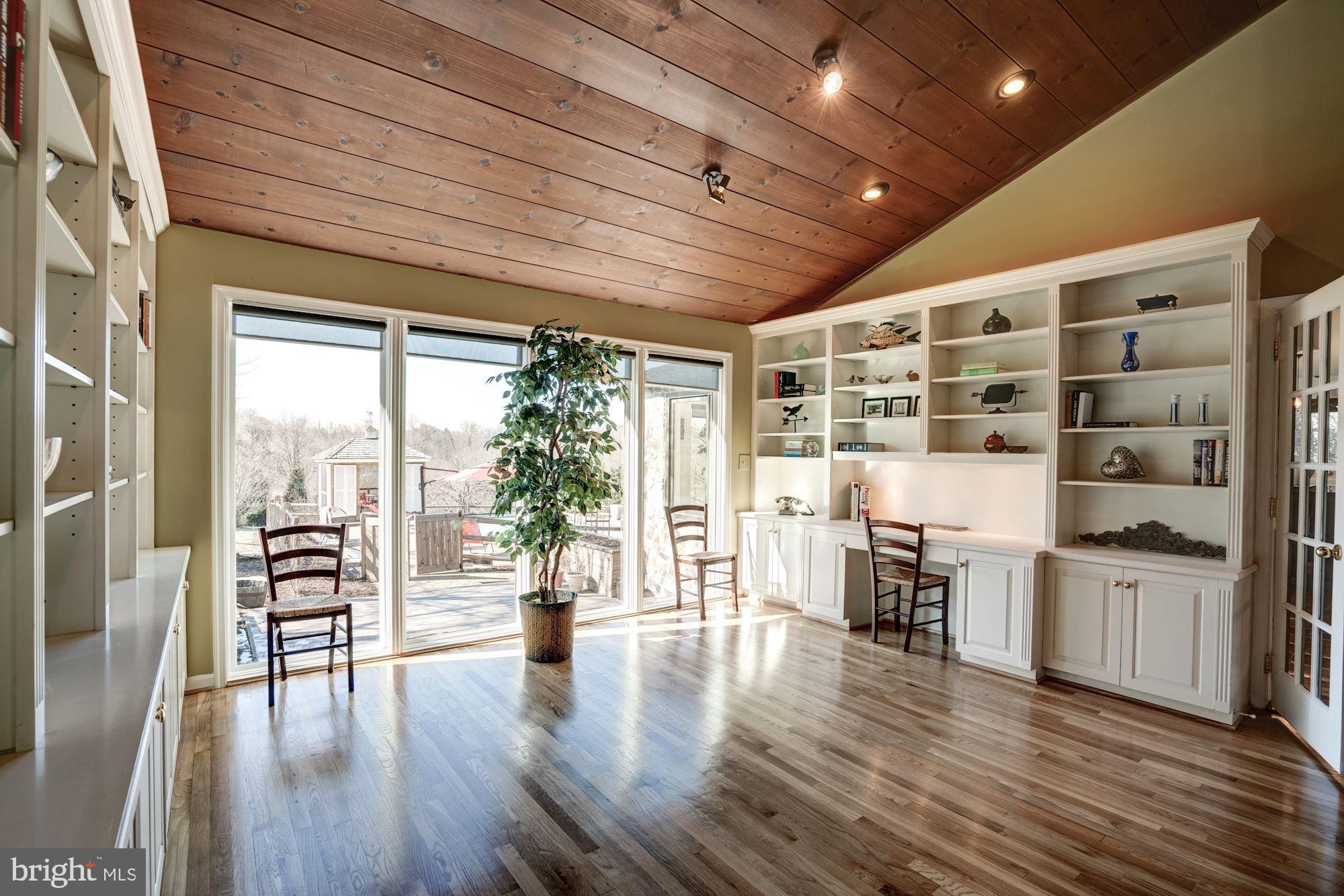 1124 Walker Road Great Falls, VA 22066 - Photo 12 of 30 Wall of windows overlooks back yard and pool.