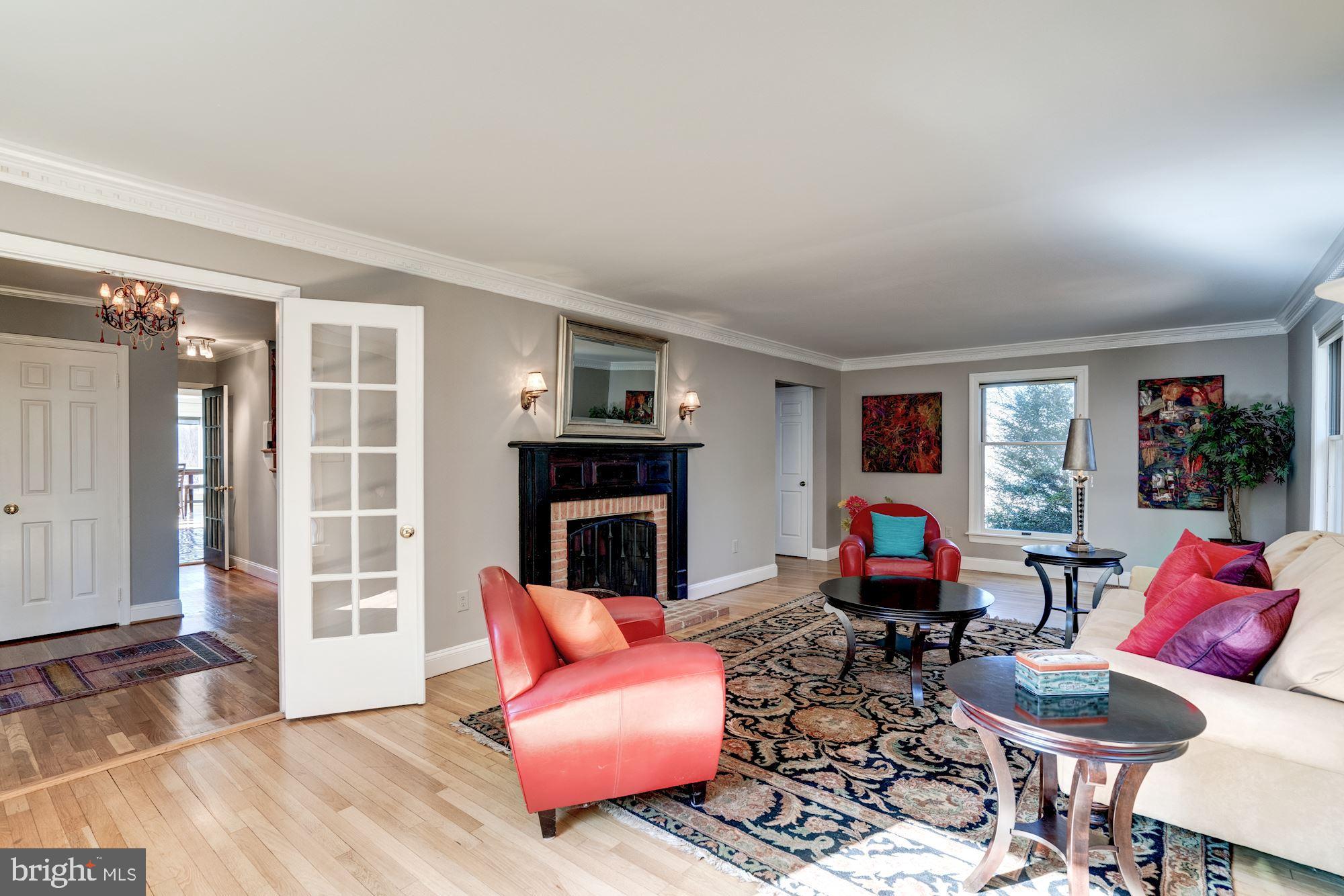 1124 Walker Road Great Falls, VA 22066 - Photo 4 of 30 Living room with crown moldings, wood fireplace.