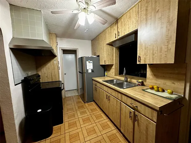 a kitchen with a sink appliances and cabinets