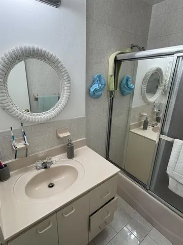 an empty room with wooden floor and fan