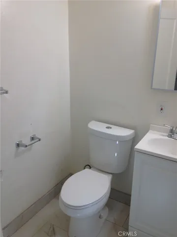 a white toilet sitting next to a bathroom sink
