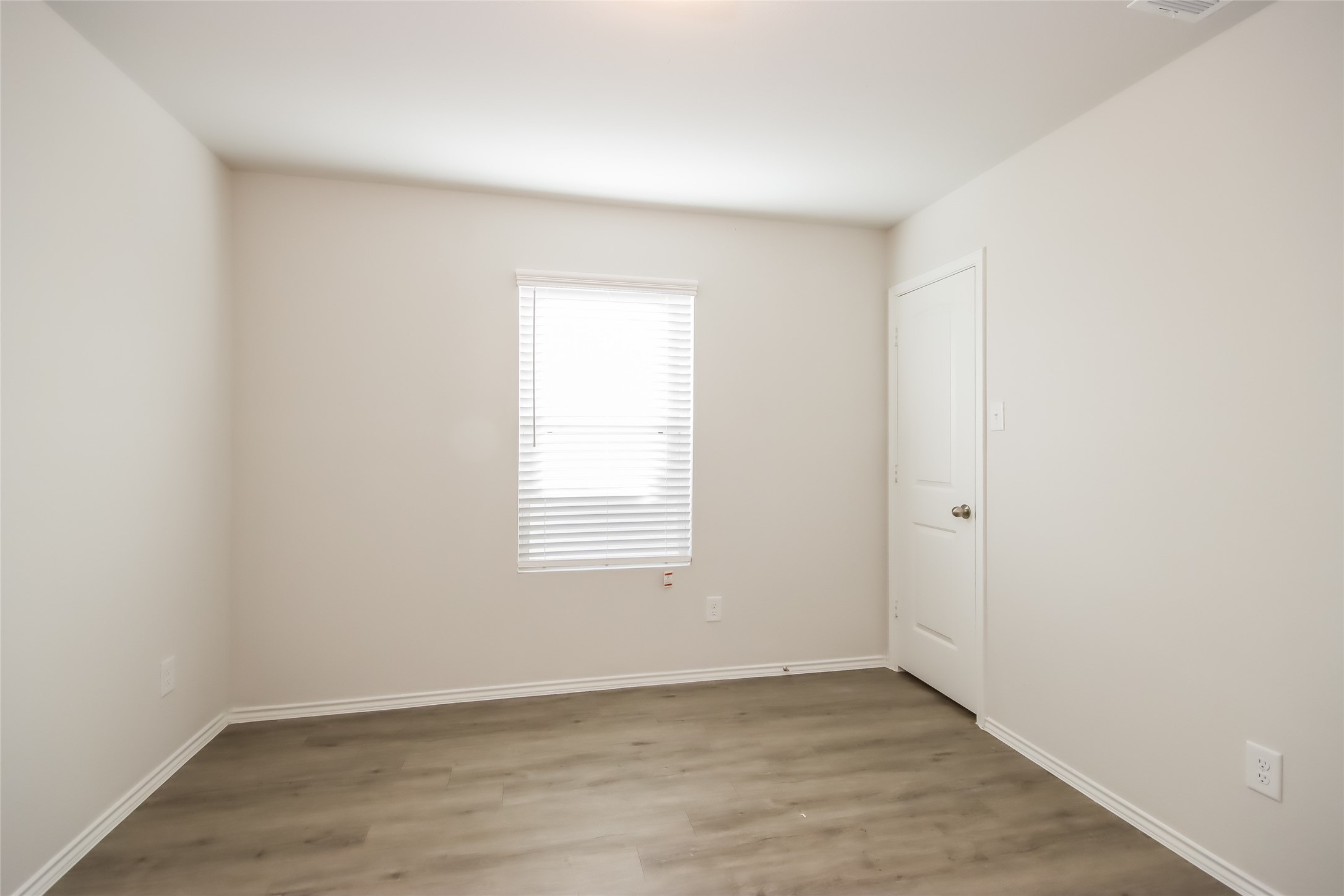 3512 Cub Court Conroe, TX 77301 - Photo 8 of 18 an empty room with wooden floor and windows