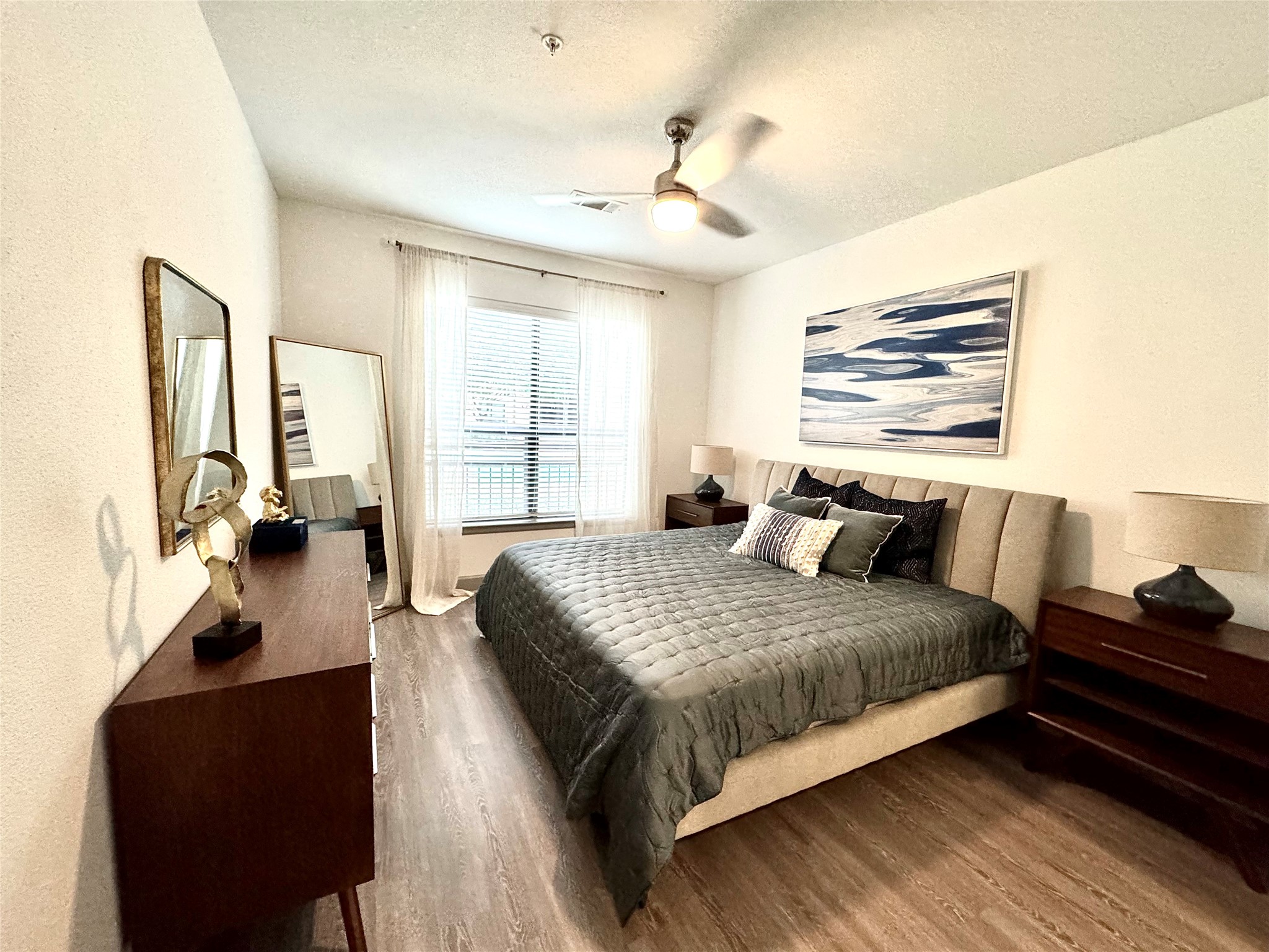 3333 Weslayan Street, Unit 1249 Houston, TX 77027 - Photo 3 of 10 a bedroom with a bed and wooden floor