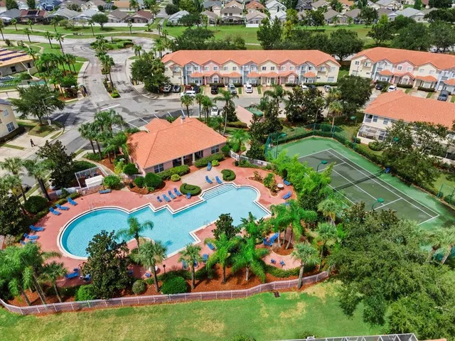 an aerial view of residential houses with outdoor space and lake view