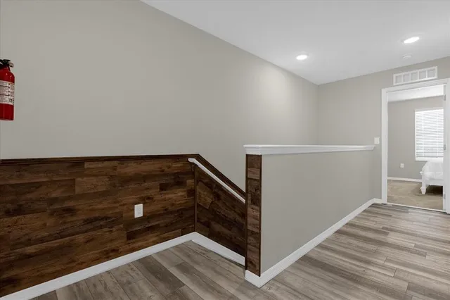 a view of an empty room and wooden floor