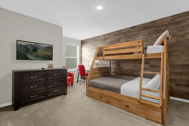 a bedroom with a bed and a flat screen television